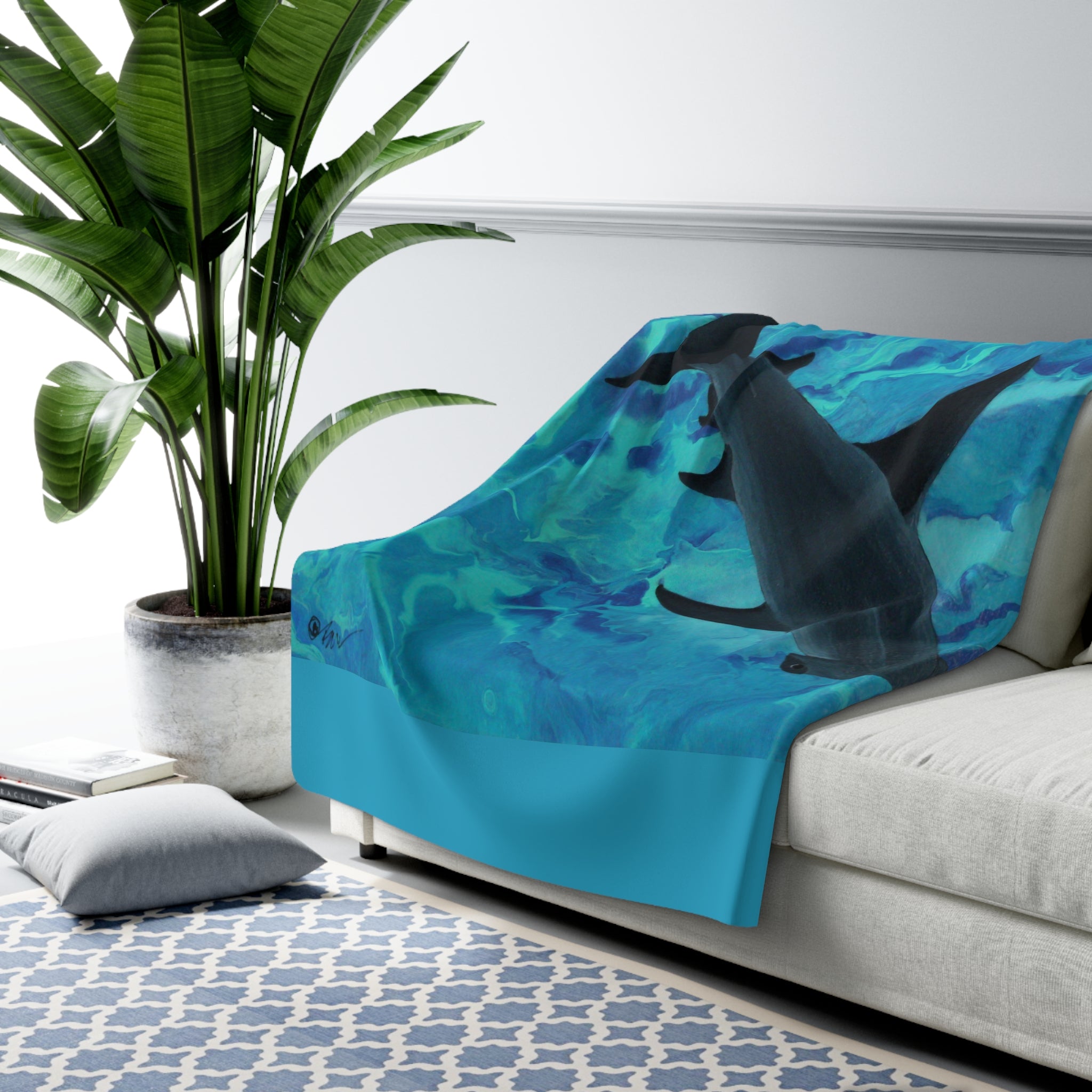 Blue blanket with shark design on a sofa in a living room setting