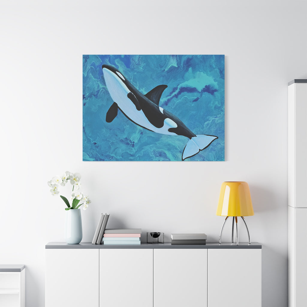 Orca whale painting on a blue abstract background above a white cabinet with decorative items.