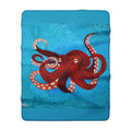 Blanket with red octopus design on a blue water background