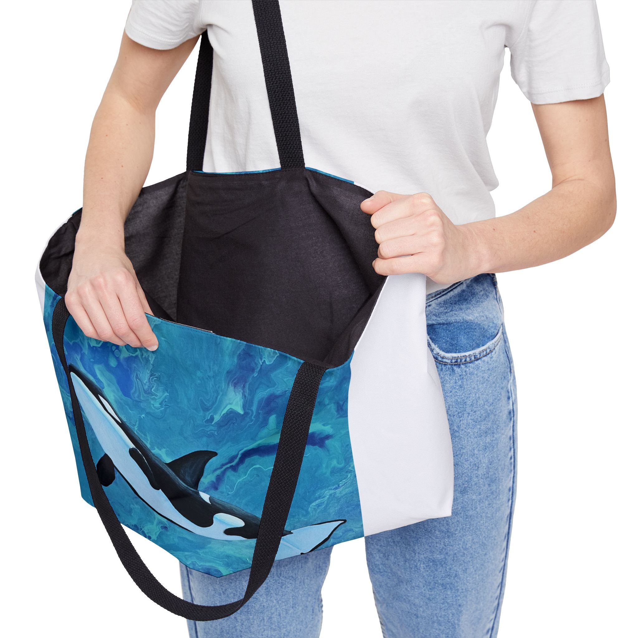 Person holding a tote bag with whale design