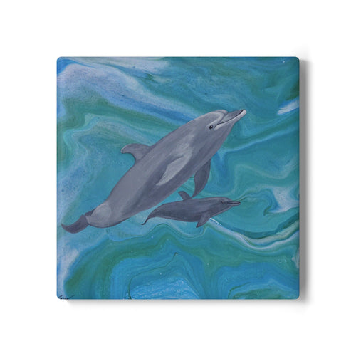 Coaster with two dolphins swimming on a blue and green abstract background