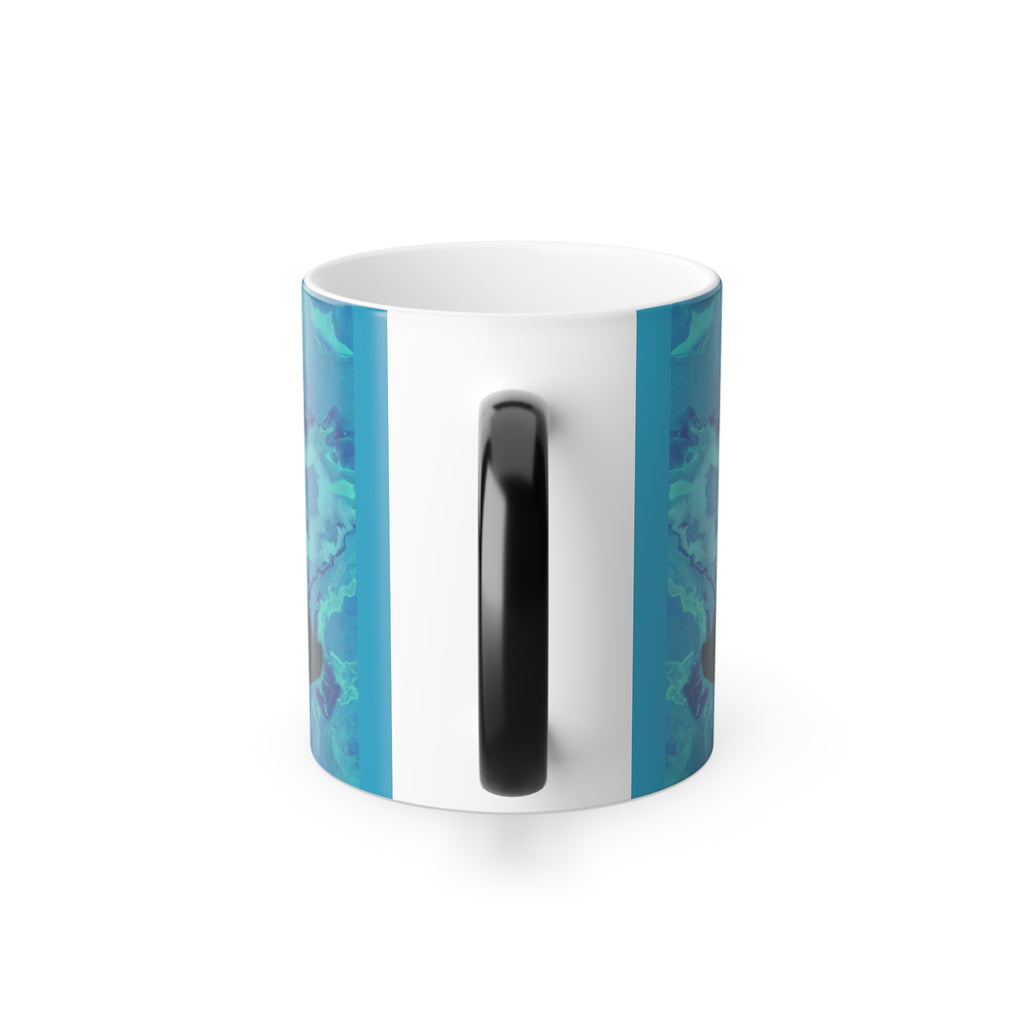 White mug with blue abstract design and black handle on a white background