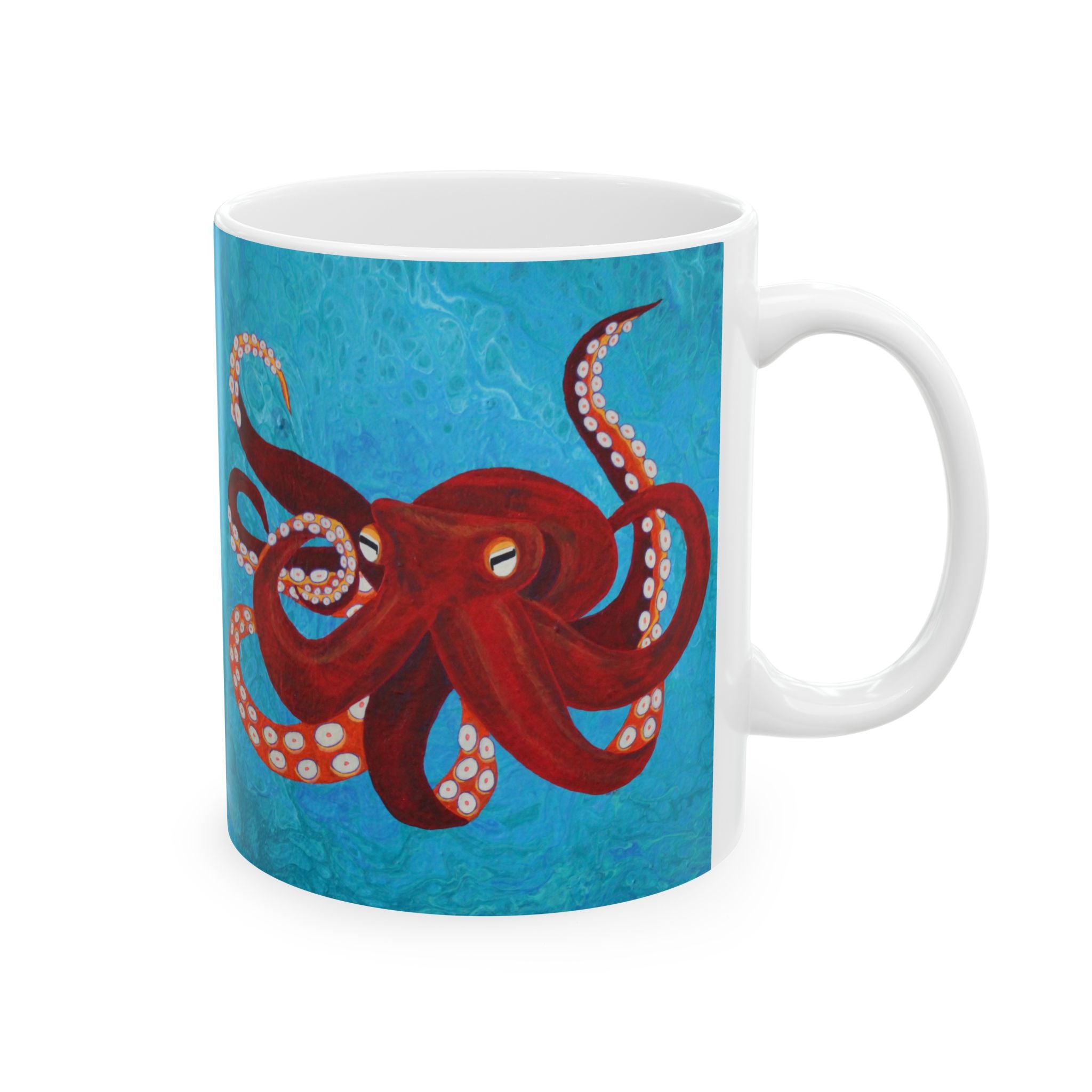 White mug with a red octopus design on a blue background