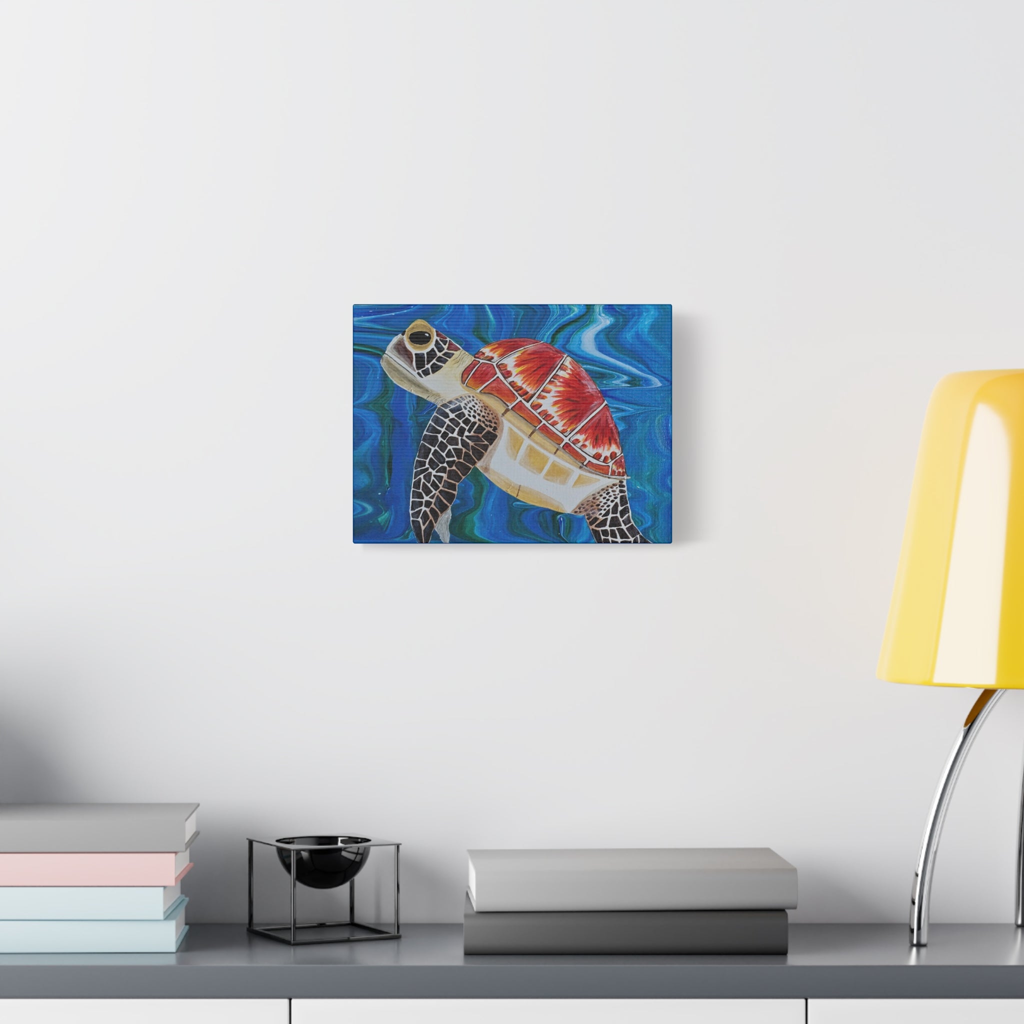 Colorful turtle painting on a wall above a desk with books and a lamp.