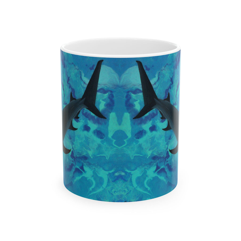 Mug with shark design on a blue and green abstract pattern