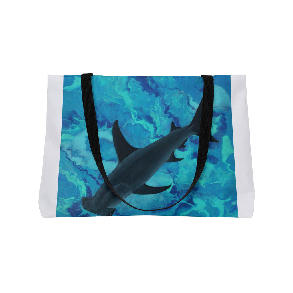 Tote bag with shark design on a blue and green patterned background