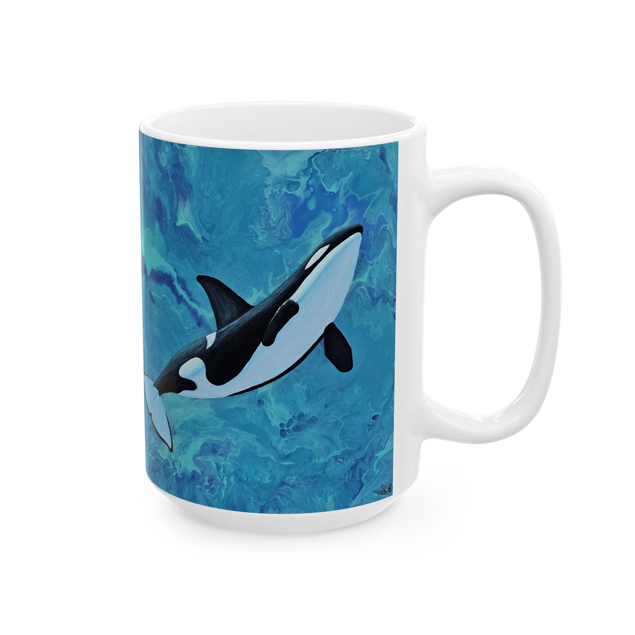 Mug with an orca whale design on a blue marbled background