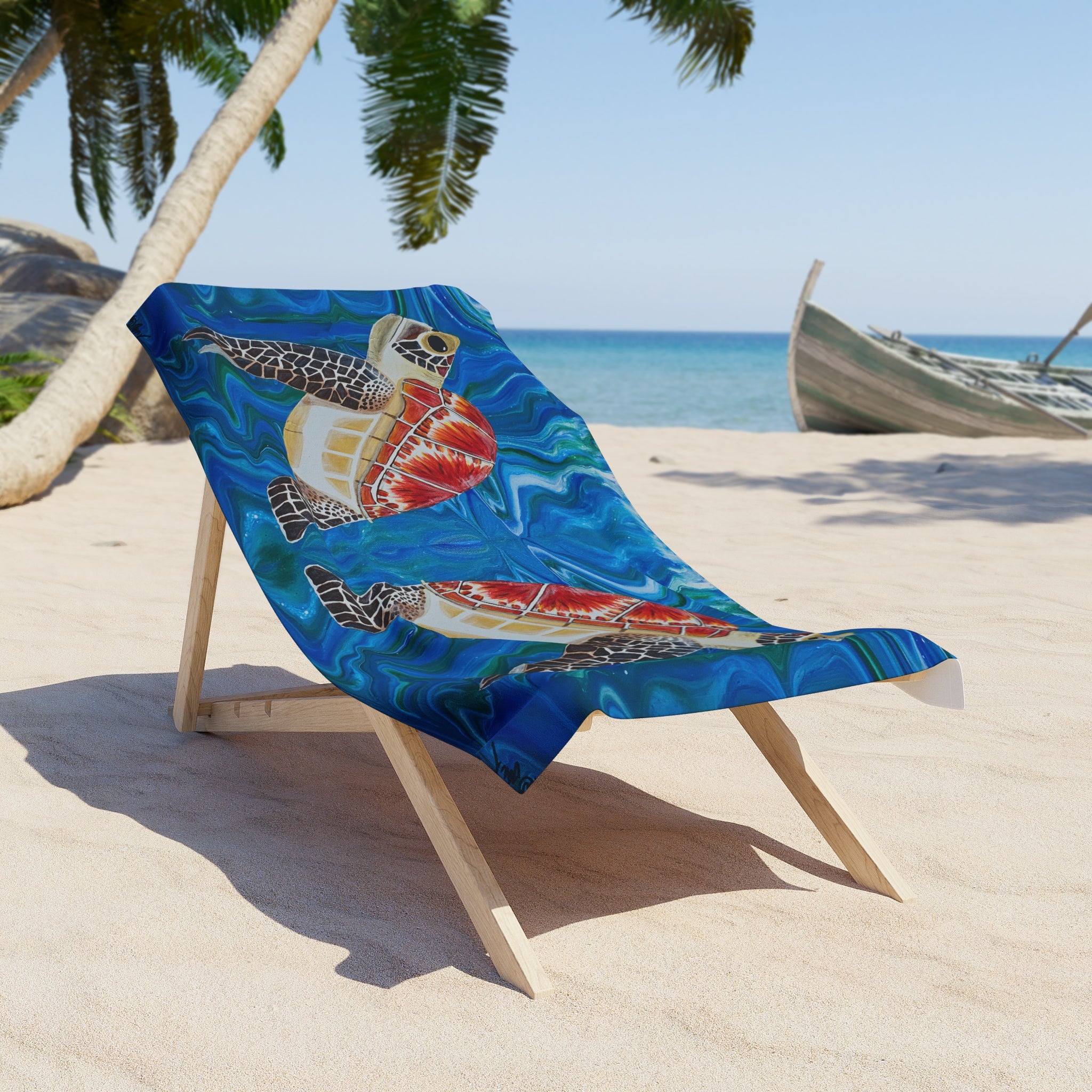 Beach towel/blanket with turtle design on a wooden chair on a sandy beach with palm trees and ocean in the background.
