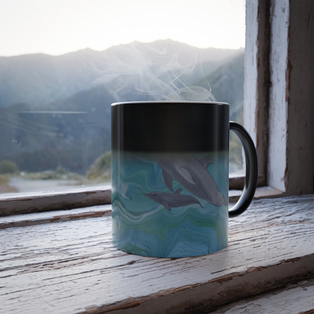 Mug with dolphin design on a windowsill with a mountain view