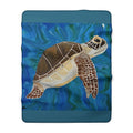 Fleece blanket with a turtle design on a blue underwater background