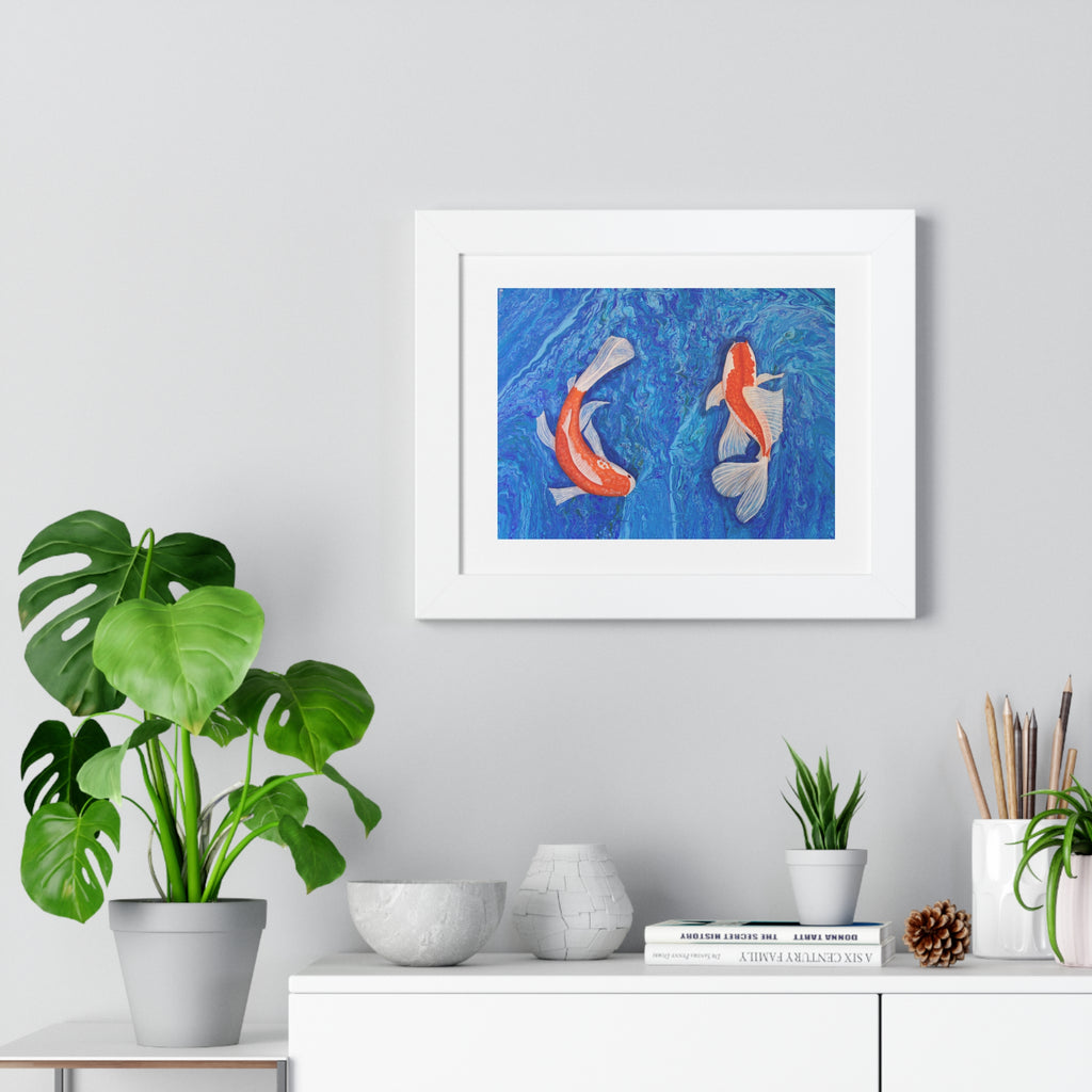 Framed artwork of two koi fish on a blue background, displayed on a wall above a white cabinet with decorative items.