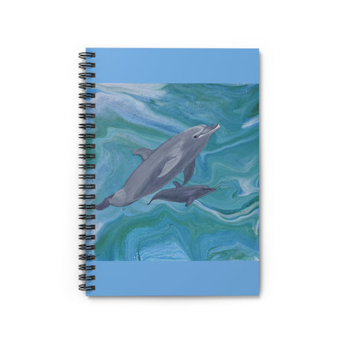 Notebook with dolphins on a wave design on a white background
