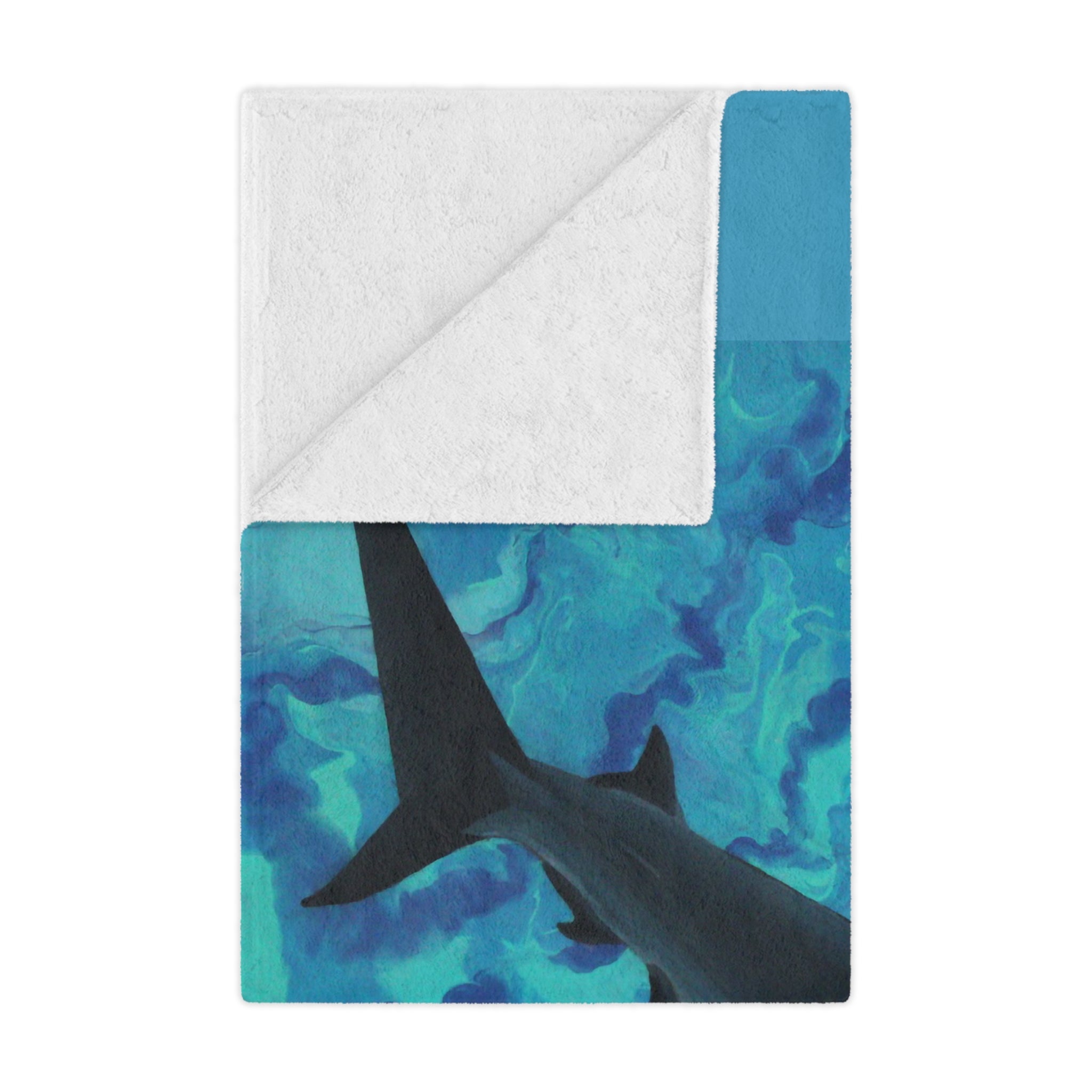 Blanket with shark design on a blue and white background