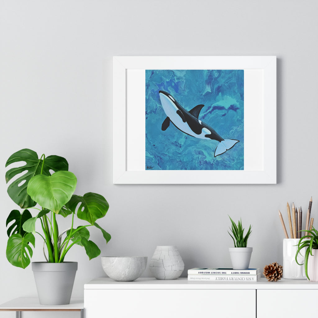 Framed artwork of an orca whale on a wall above a white cabinet with plants and decor.