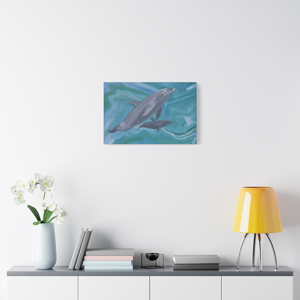 Framed artwork of dolphins on a wall above a shelf with decor items.