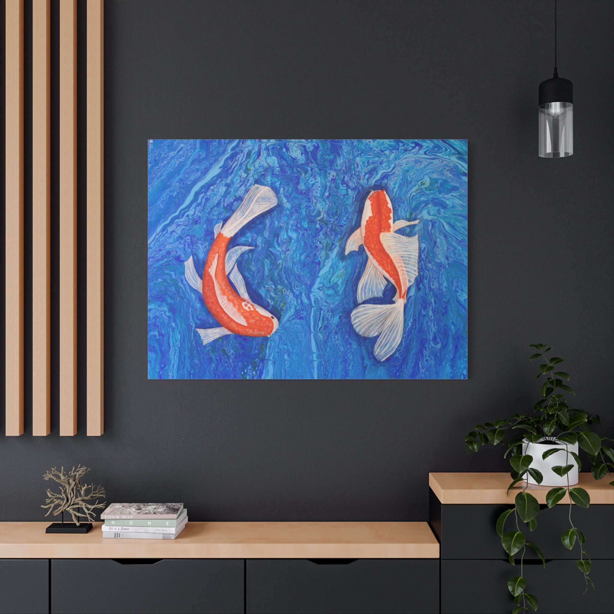 Framed artwork of two koi fish on a blue background in a modern interior setting.