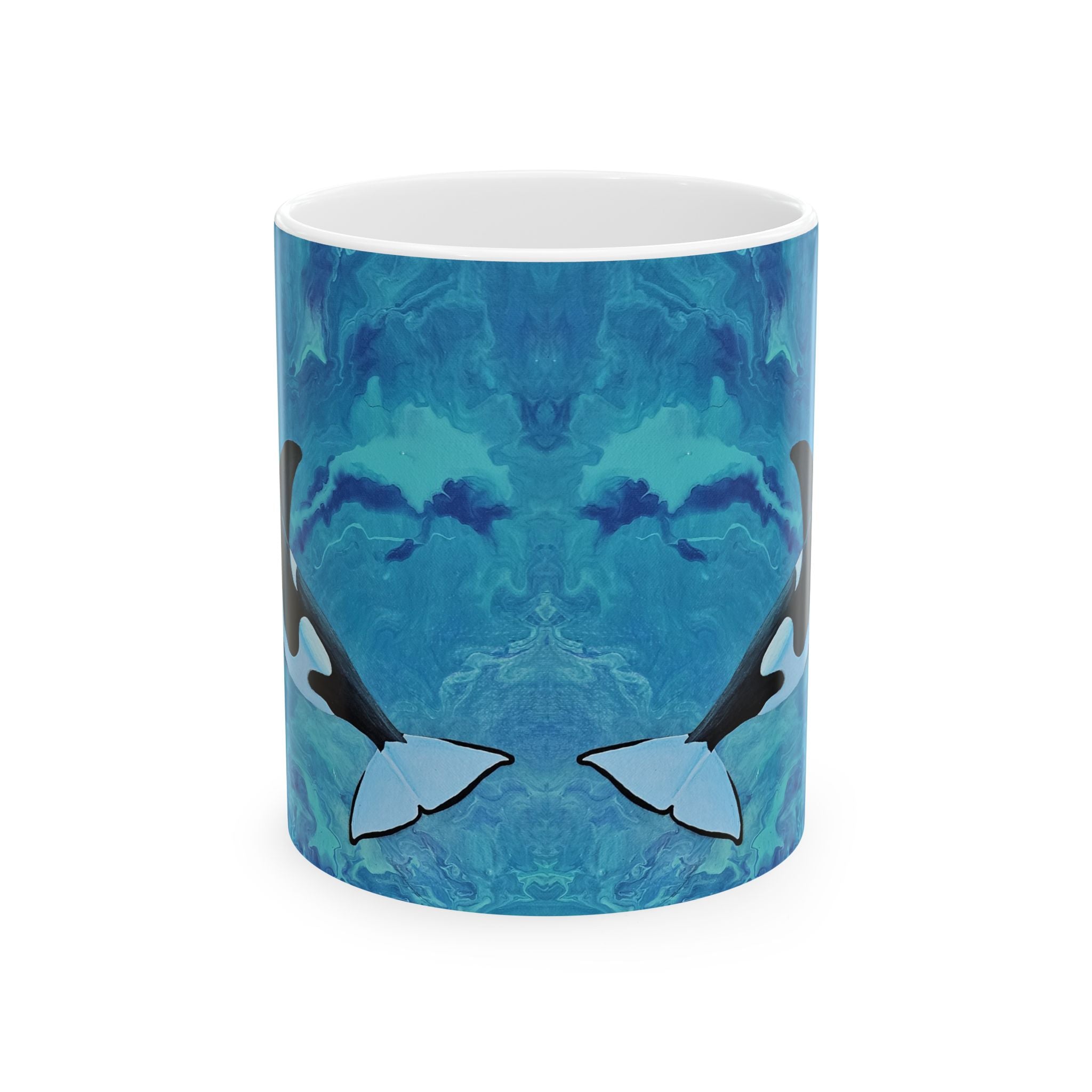 Mug with blue abstract design featuring orca whales on a white background