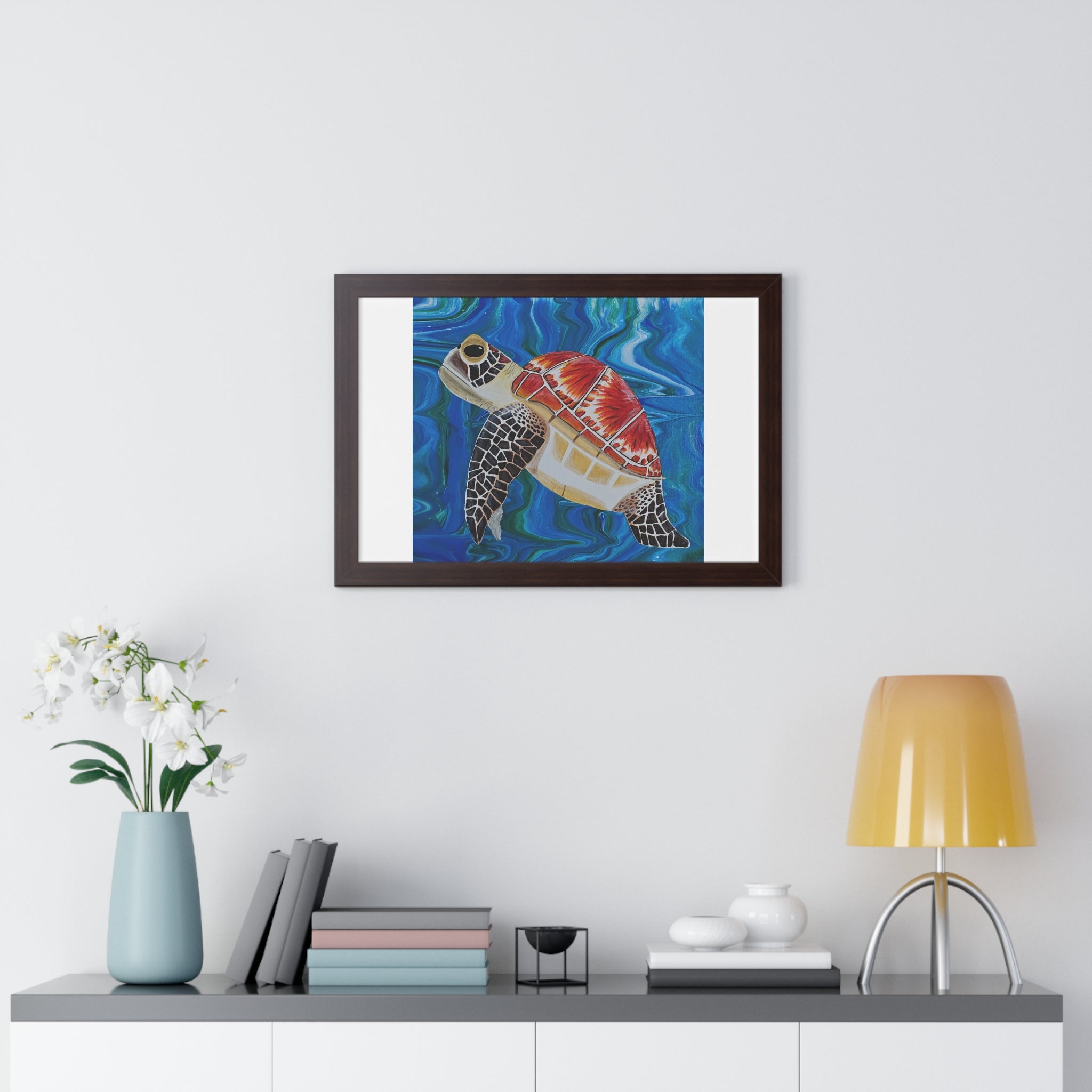 Framed artwork of a turtle on a wall above a shelf with decor items.
