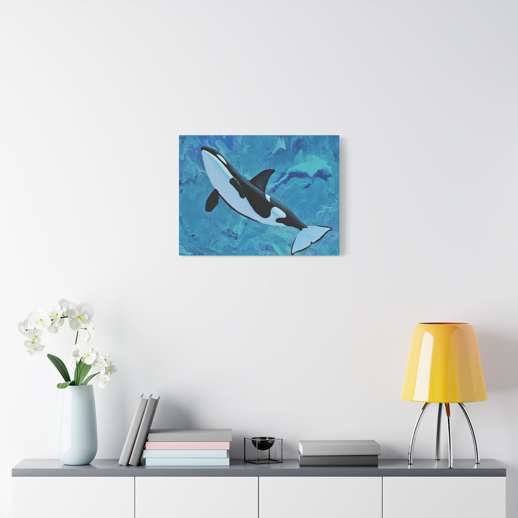 Orca whale painting on a wall above a shelf with decor items.