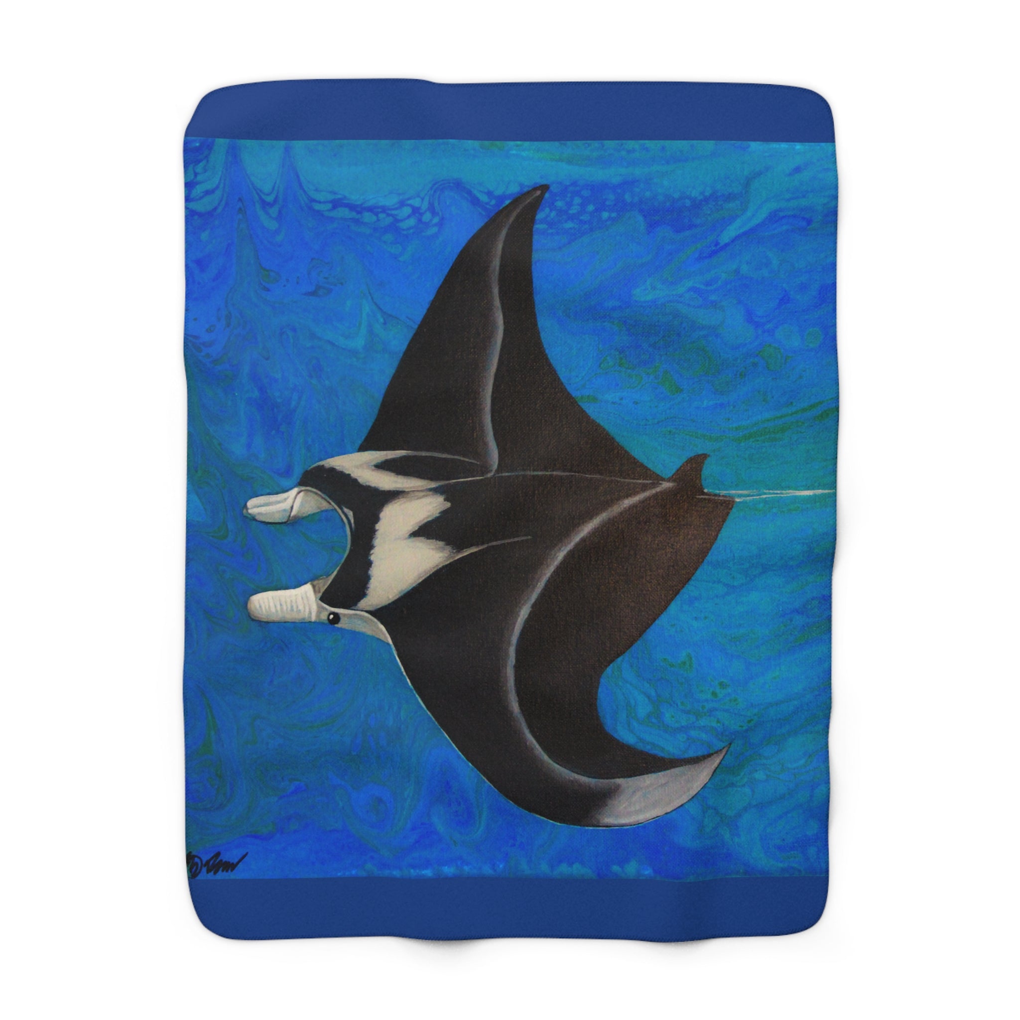 Fleece blanket with a manta ray design on a blue background