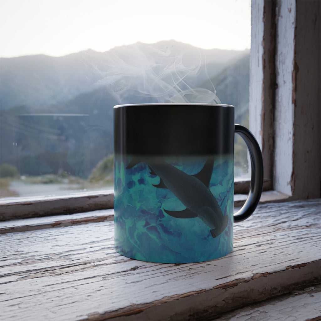 Mug with shark design on a windowsill with mountain view