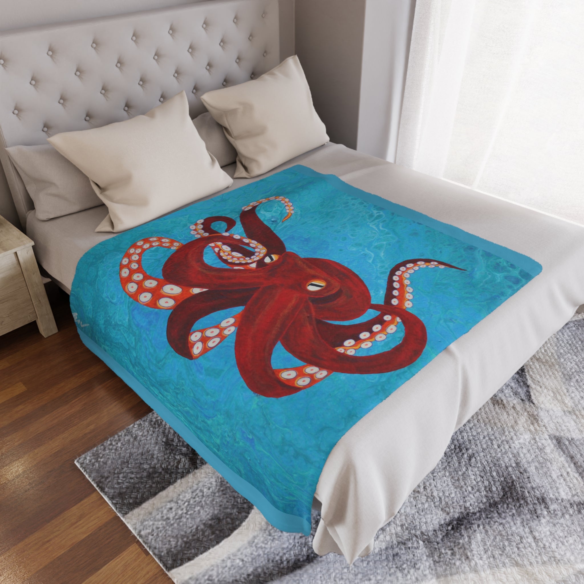 Bed with a red octopus design blanket on a blue background