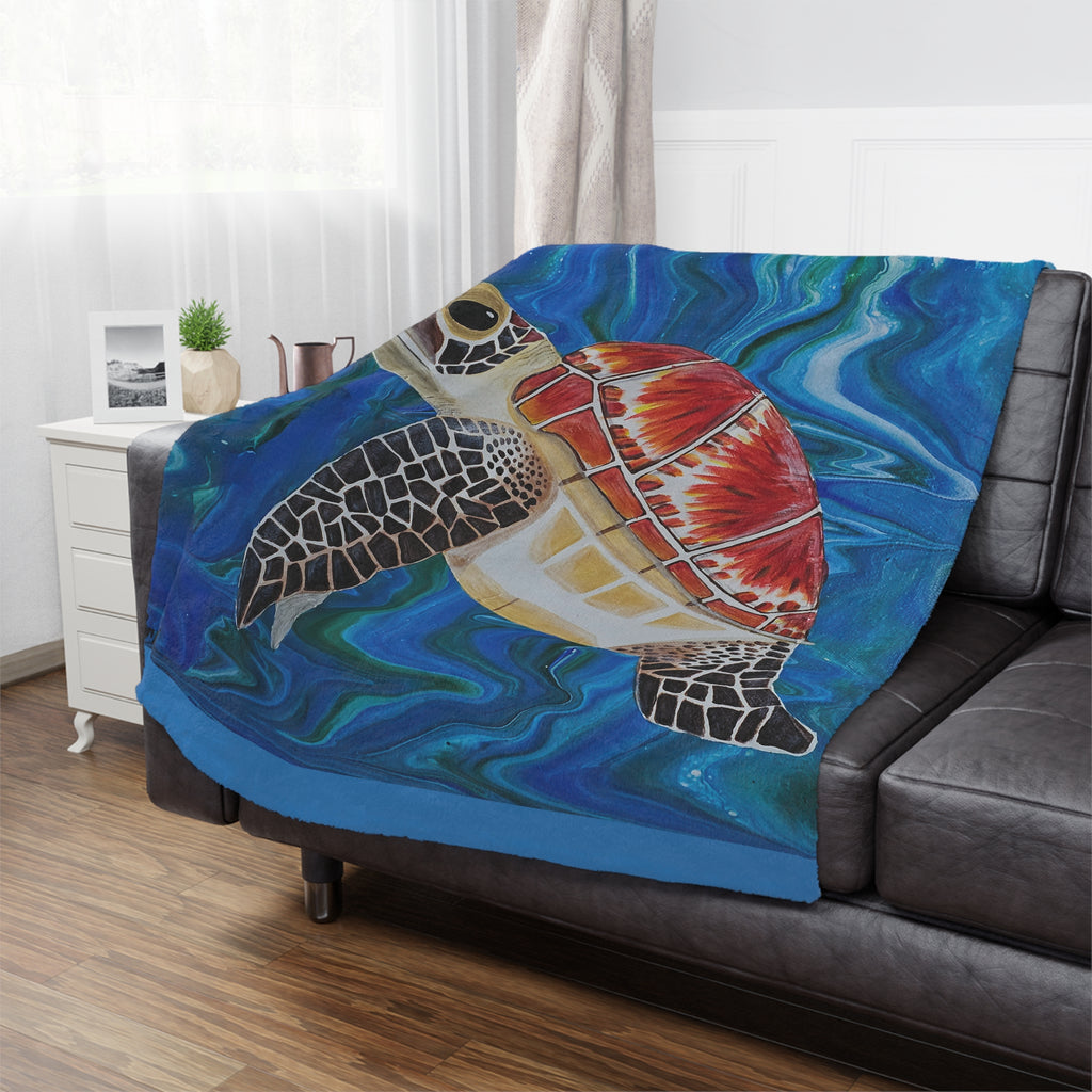 Colorful turtle blanket draped over a sofa in a living room setting.