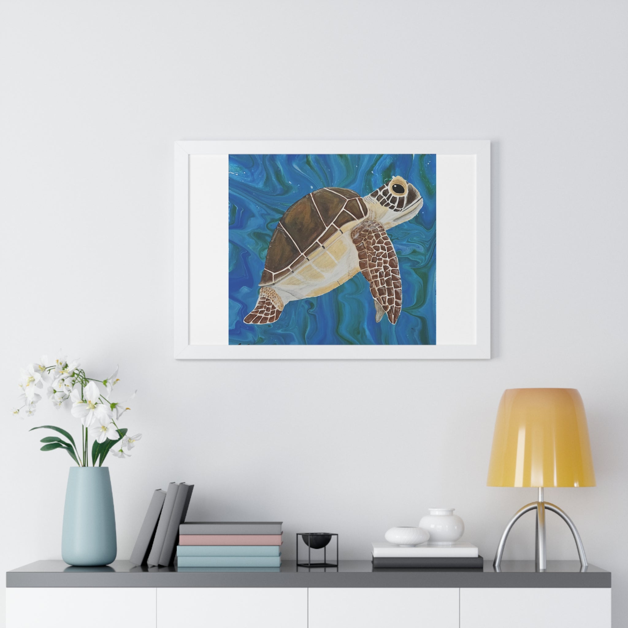 Framed artwork of a turtle on a wall above a shelf with decor items.