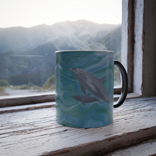 Mug with dolphin design on a wooden surface with a mountain view