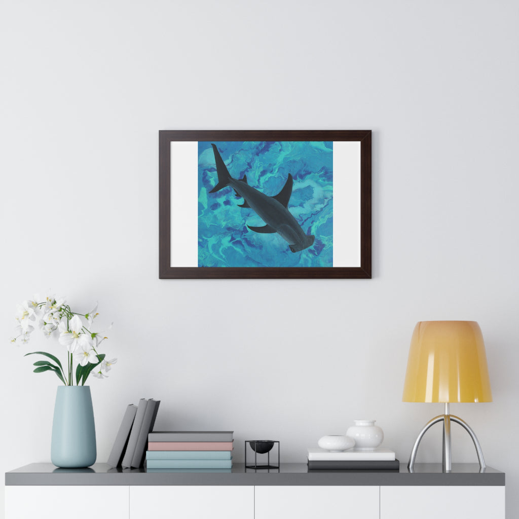 Framed artwork of a shark in water on a wall above a shelf with decor items.