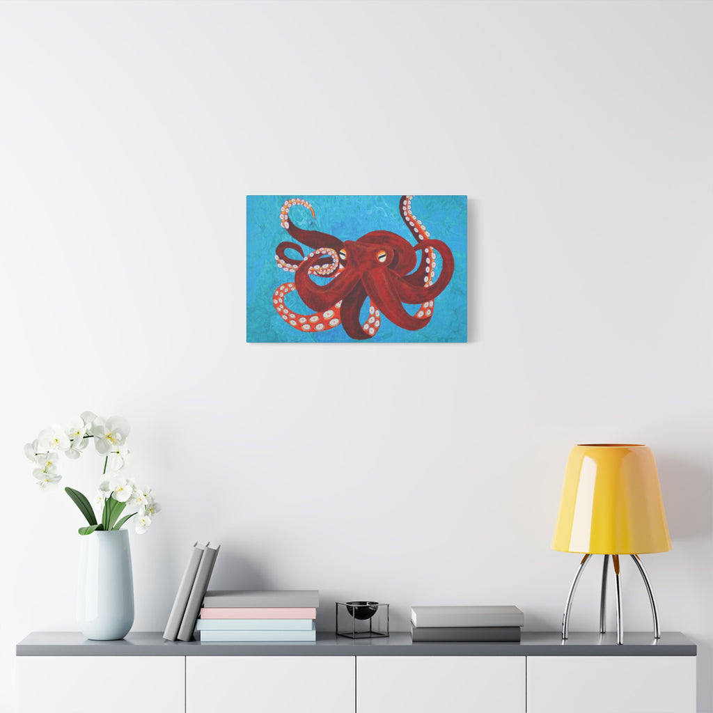Red octopus painting on a white wall above a shelf with decor items.