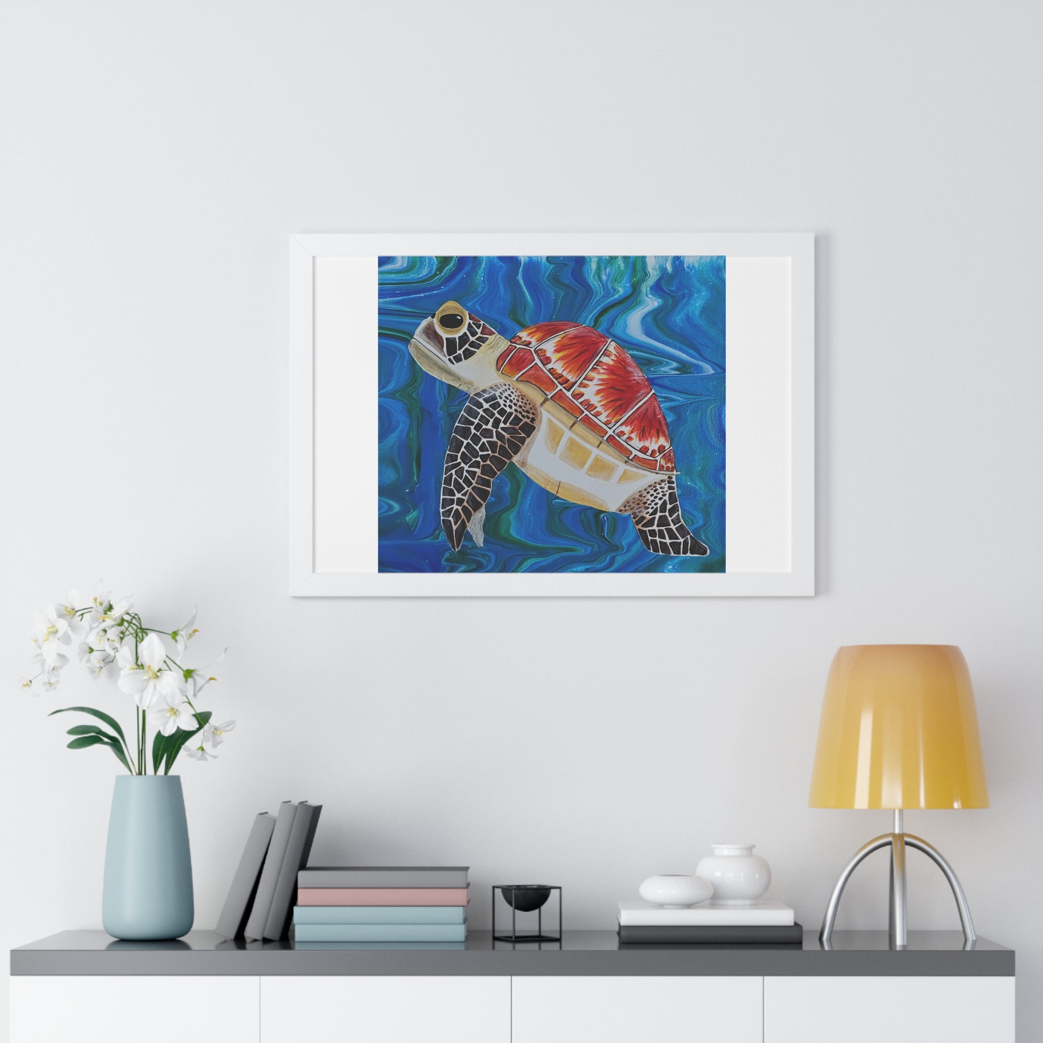 Framed artwork of a colorful turtle on a wall above a shelf with decor items.