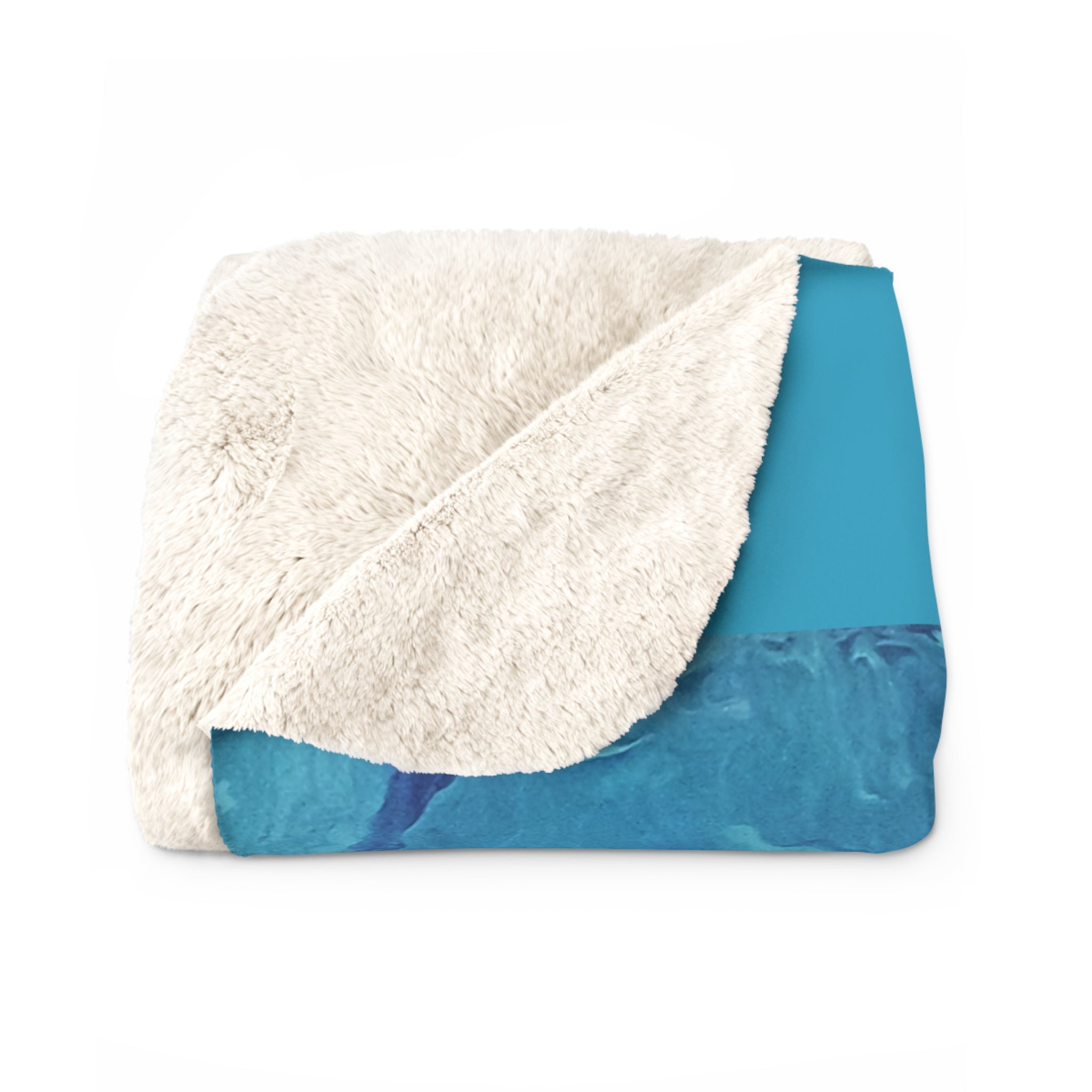 Folded blanket with white sherpa on one side and blue fabric on the other, on a white background