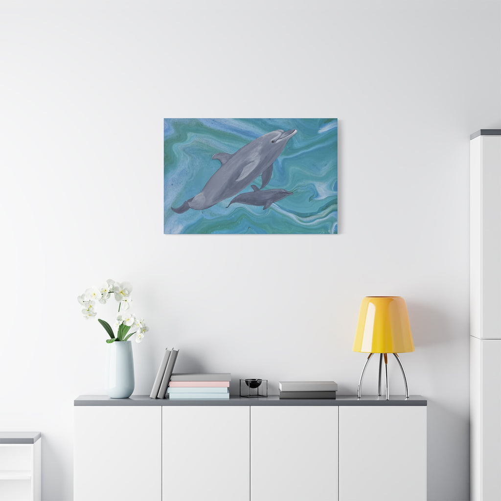 Dolphin painting on a wall above a white cabinet with a yellow lamp and white flowers.