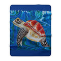 Folded blanket with a turtle design on a blue background