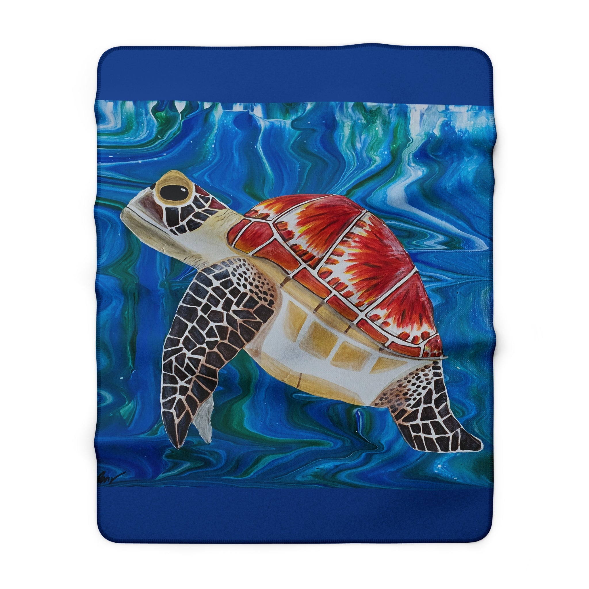 Folded blanket with a turtle design on a blue background