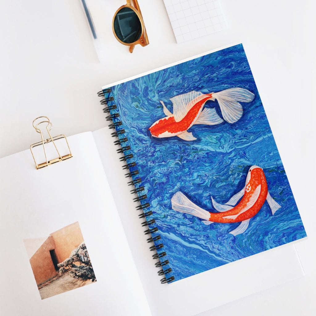 Notebook with koi fish design on a white surface