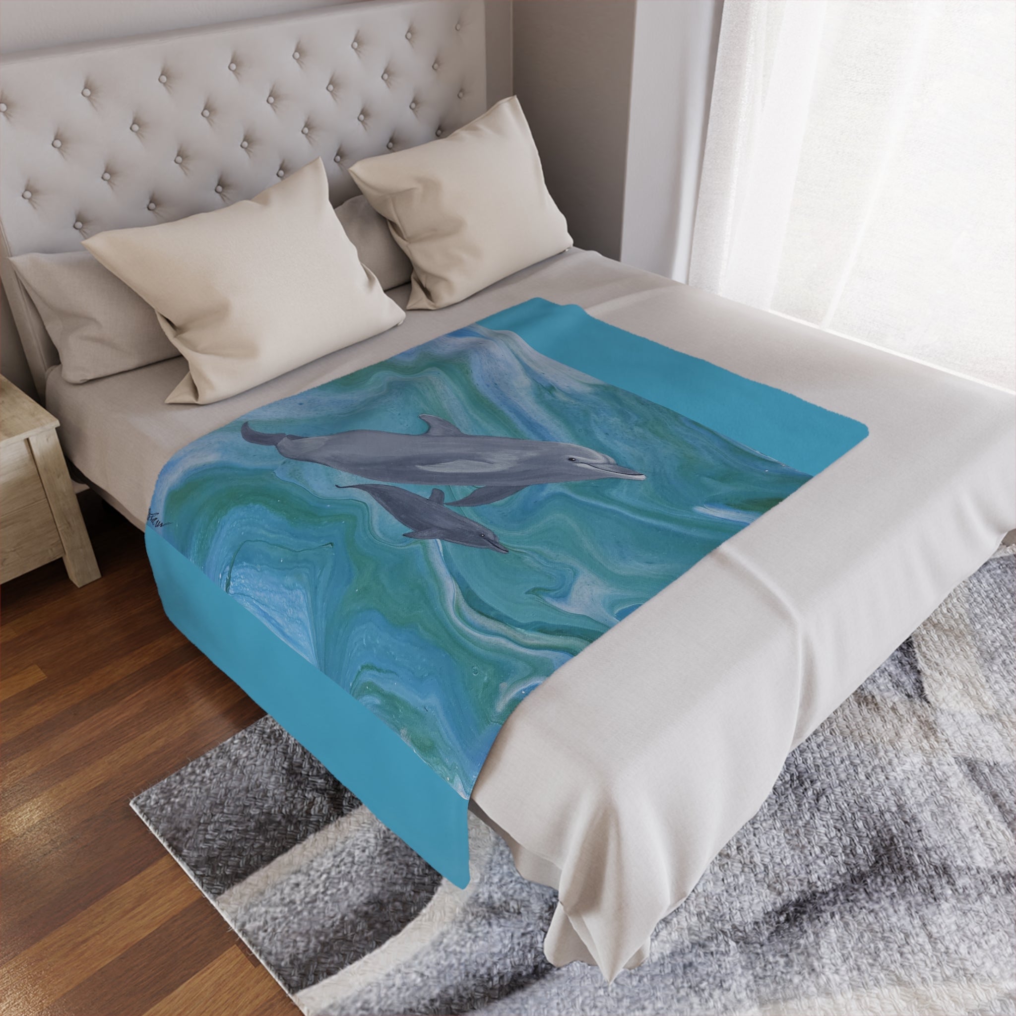 Bed with a decorative blanket featuring dolphins in water design