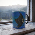 Mug with a manta ray design on a windowsill with a mountain view.