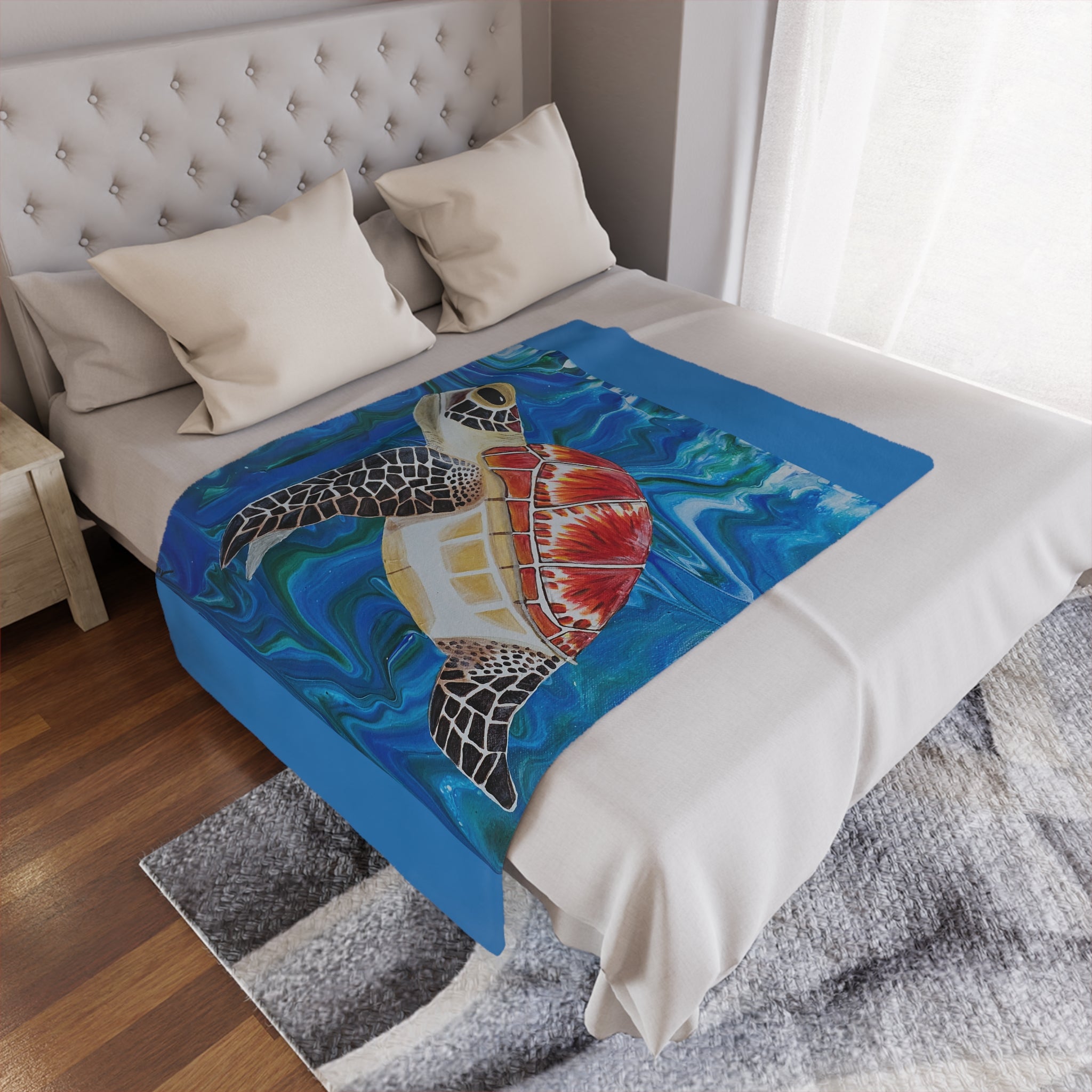Bed with a colorful turtle design blanket draped over it in a bedroom setting.