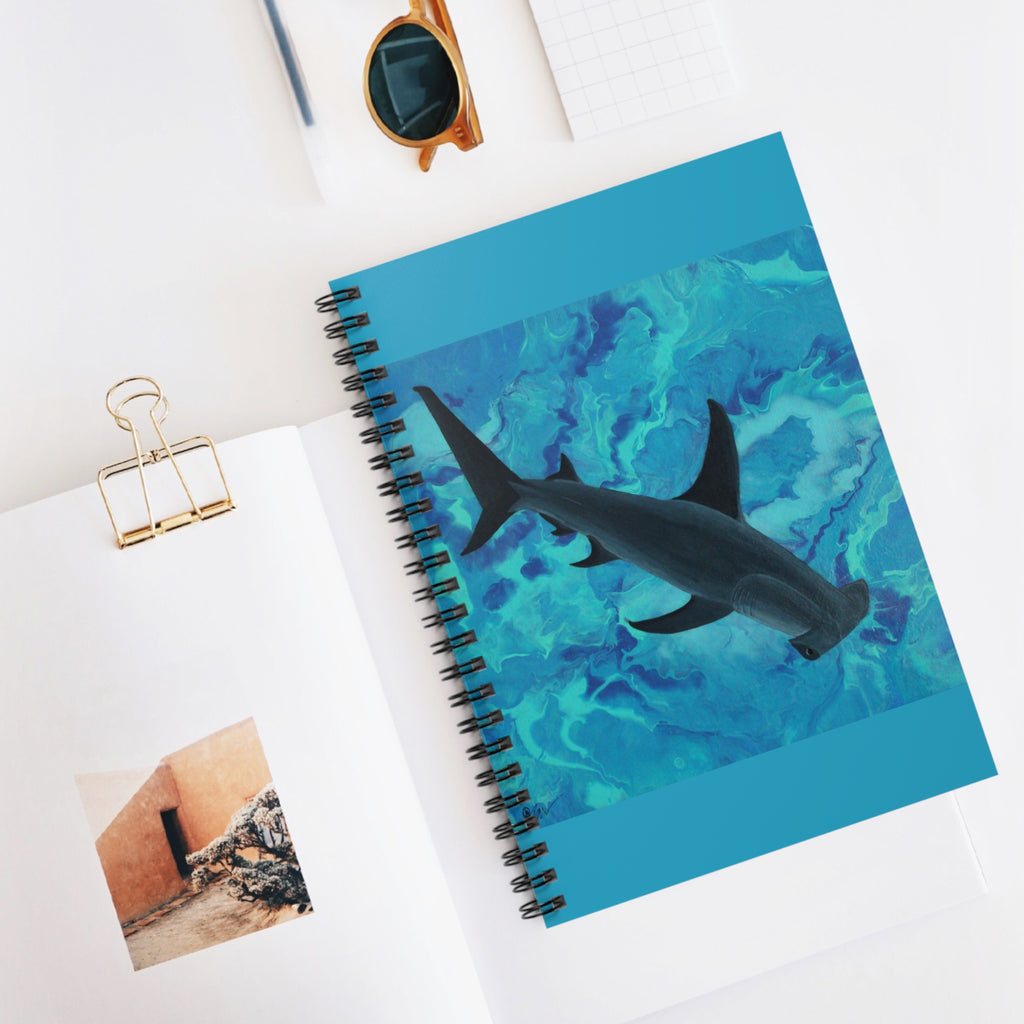 Notebook with a shark design on a white surface