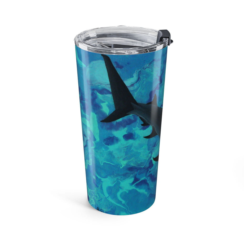 Tumbler with blue marbled design and shark silhouette on a white background