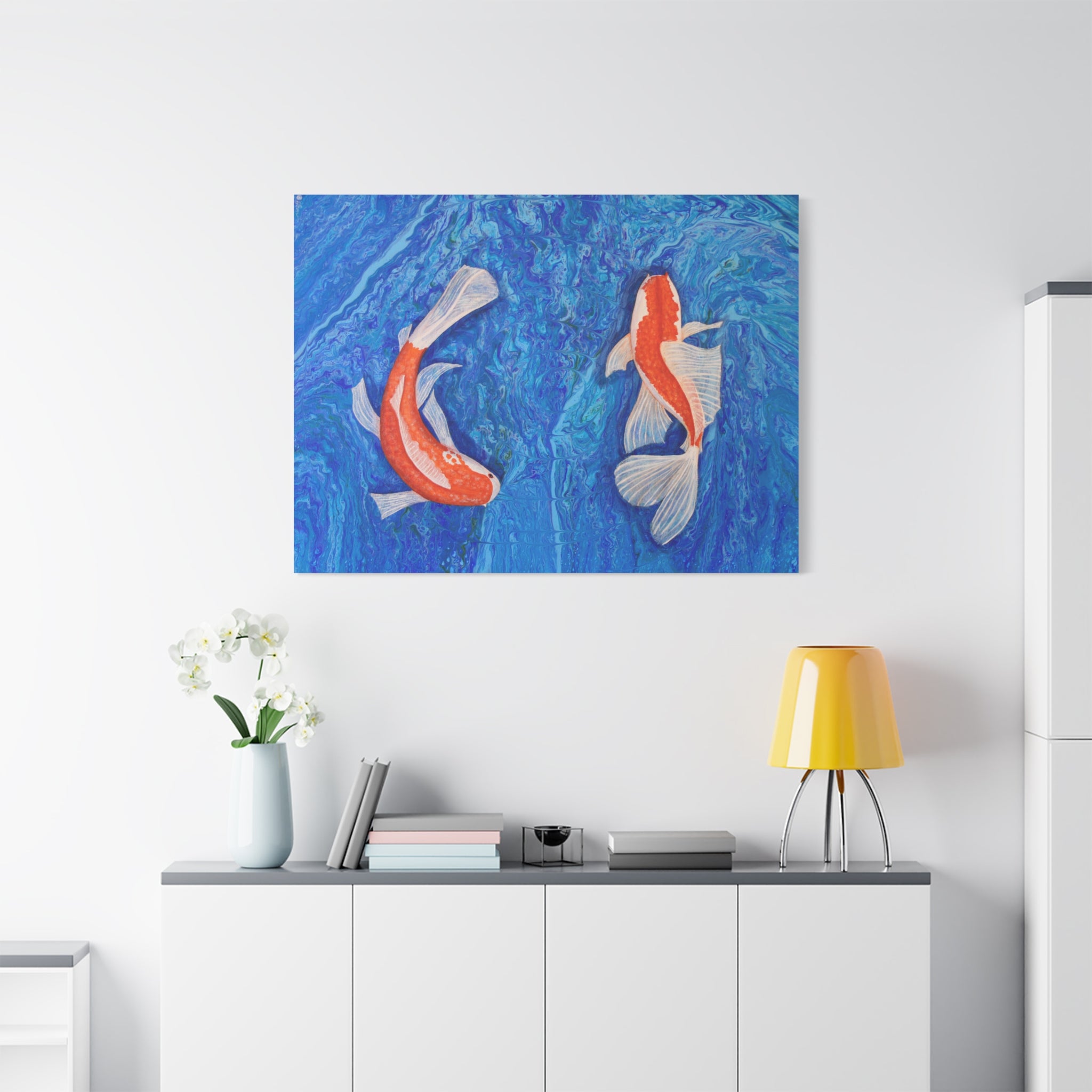Canvas print of two koi fish on a blue wave background in a modern interior setting.