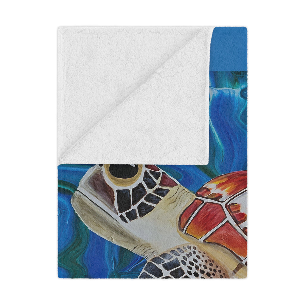 Colorful turtle design on a folded blanket with a white border