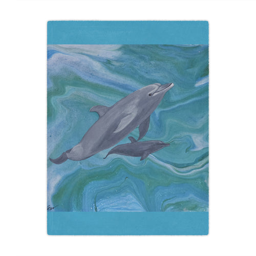 Blanket with a design of two dolphins on a blue and green abstract background
