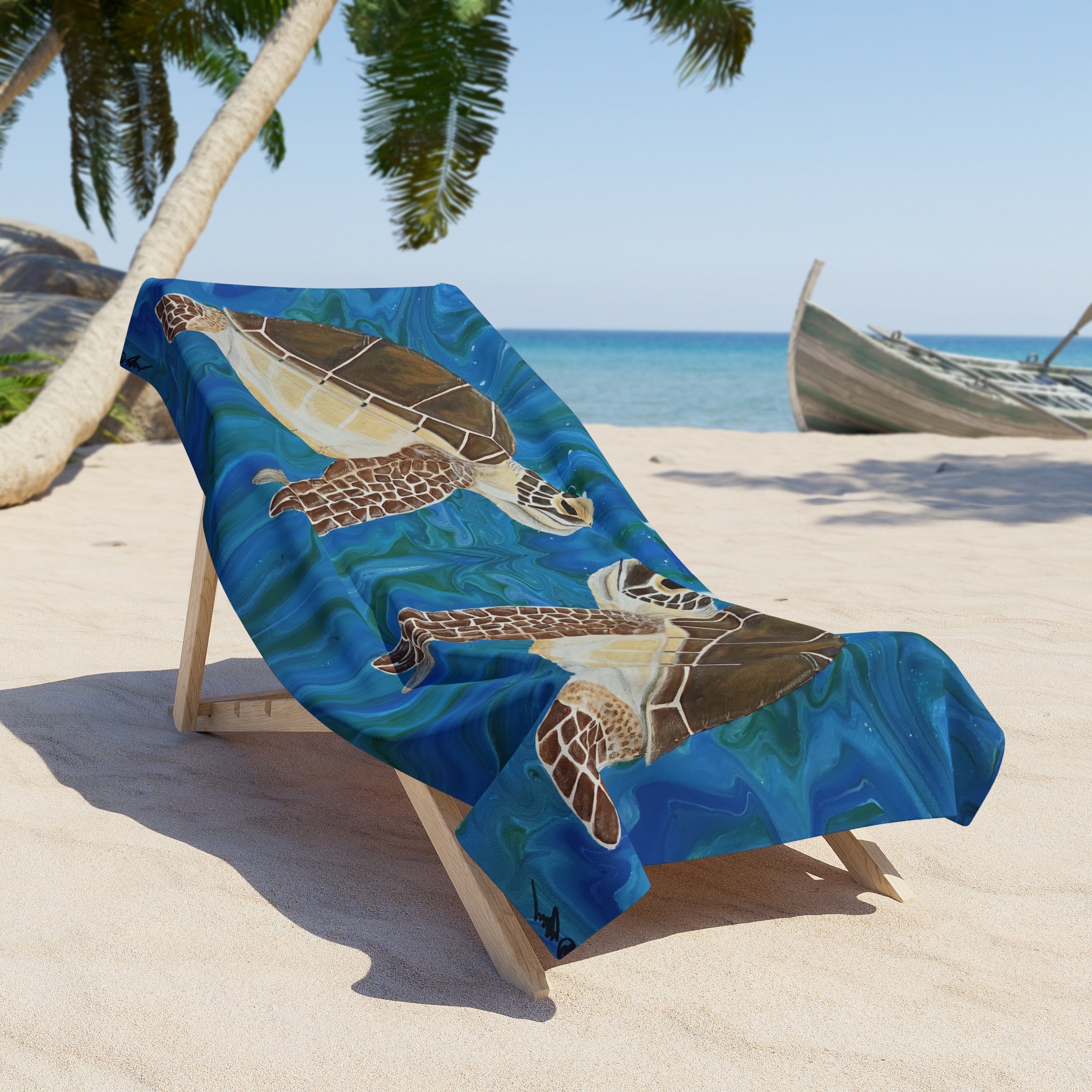 Beach towel/blanket with turtle design on a chair at a tropical beach.
