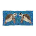 Towel/blanket with a design of two turtles on a blue water background
