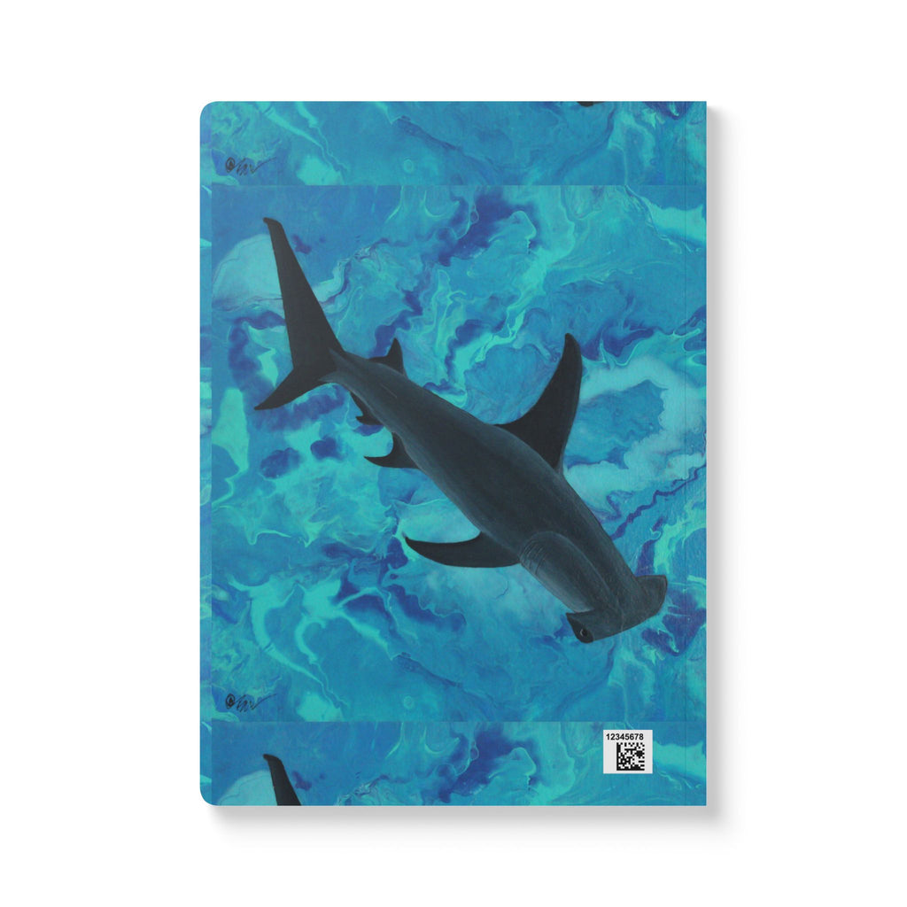 Notebook with a shark design on a blue abstract patterned cover