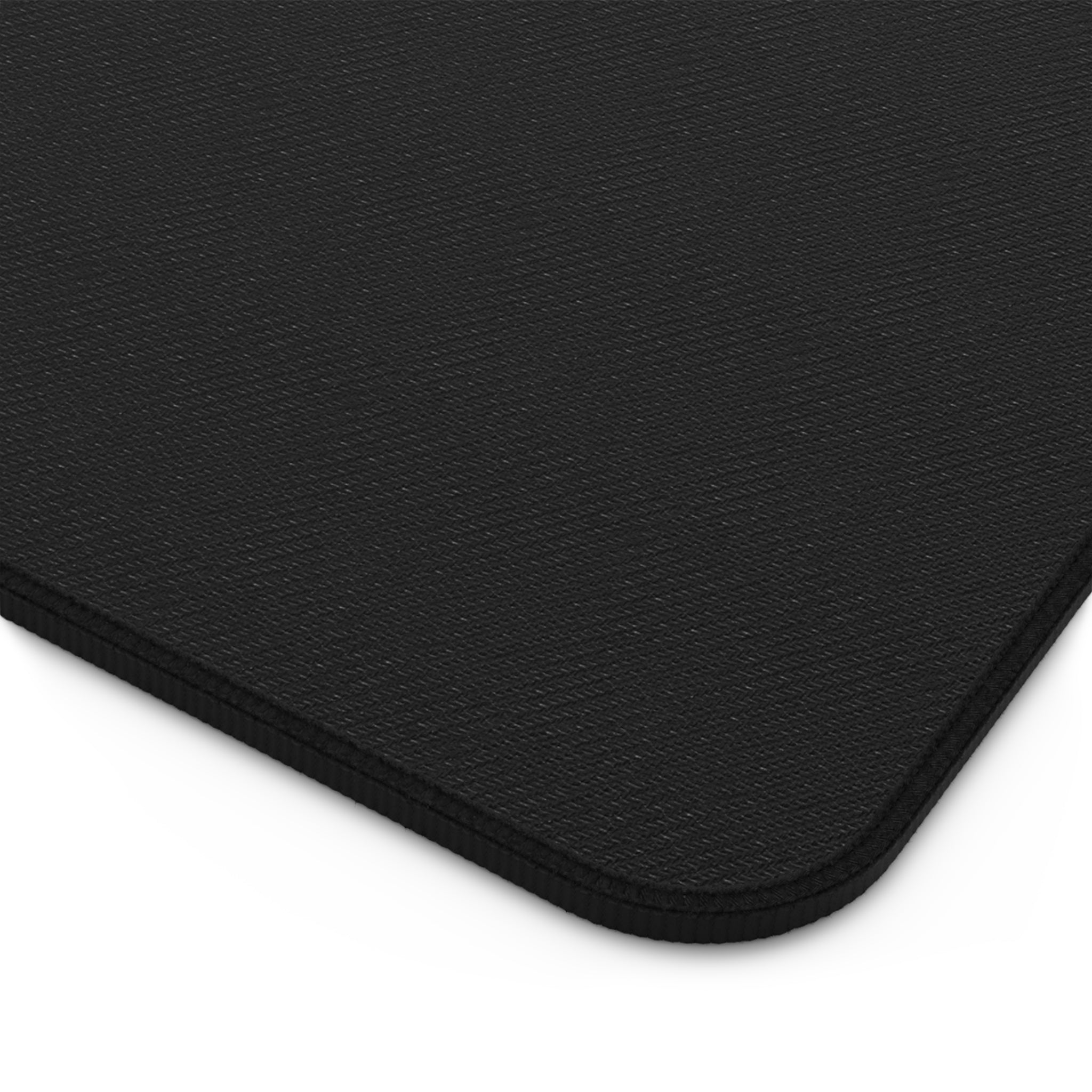 Close-up of a black backing of desk pad with a textured surface.