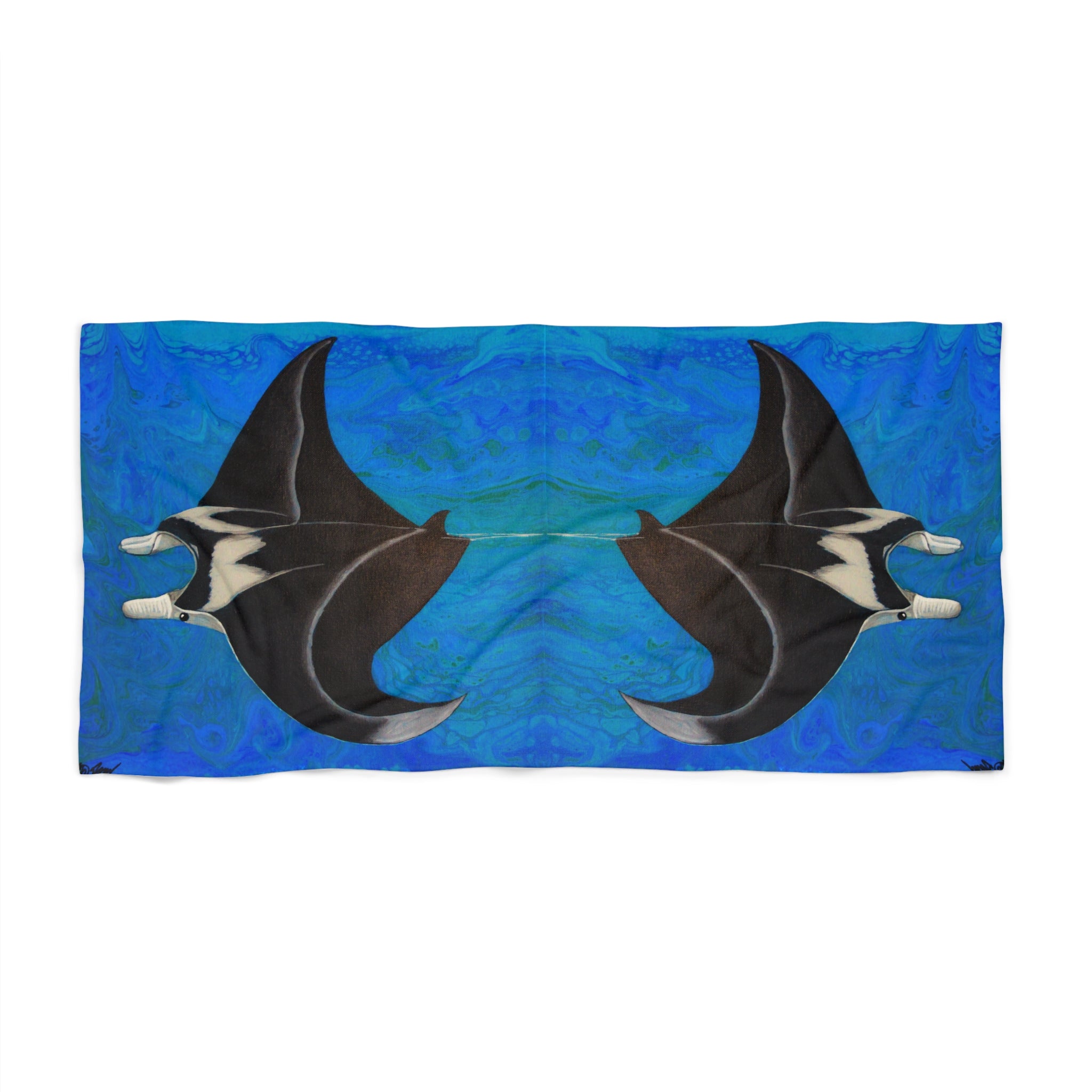 Beach towel/blanket with manta ray design on a blue background
